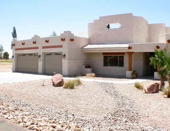 Santa Fe style stucco house with a three-car garage