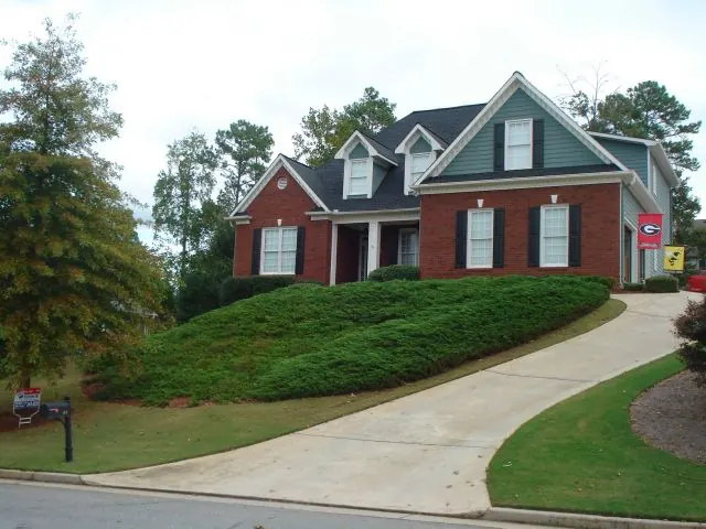 Brick and siding house with a curved front walk
