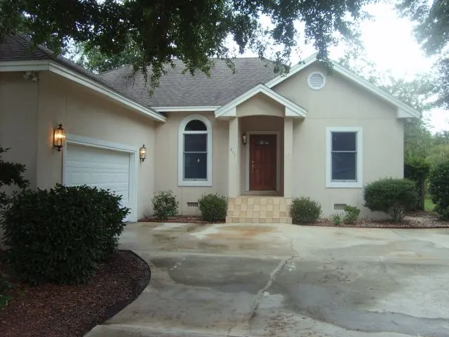 Single-story stucco home with an attached garage